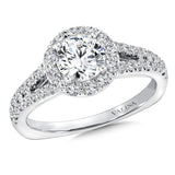 A delicate diamond split shoulder supports a dazzling round center stone in this classic halo design.