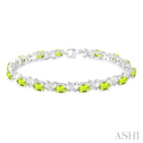 7x5  MM Oval Cut Peridot and 1/20 Ctw Round Cut Diamond Fashion Bracelet in Sterling Silver