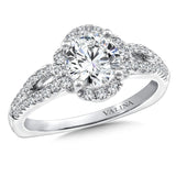 Diamond halo engagement ring mounting with split shank and side stones set in 14k white gold.