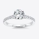 Solitaire engagement ring with diamond side stones set in 14k white gold.