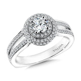 A double halo accentuates the center stone, while two delicate diamond bands gently split creating a small airline.