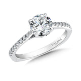 A unique diamond finger rest in this beautiful solitaire ring design sets the stage for the dazzling center stone.