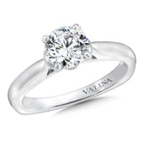 A polished cape design with surprise diamond adds a modern touch to this classic solitaire ring.