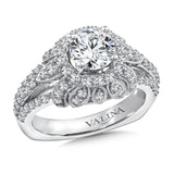 Diamond halo engagement ring mounting with a milgrain decorative skirt and side stones set in 14k white gold.