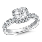 Diamond halo engagement ring mounting with side stones set in 14k white gold.