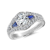 Diamond and sapphire engagement ring mounting with tapered baguettes and round side stones set in 14k white gold.