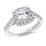 A sparkling cushion shape diamond halo lights up the princess-cut center in this classic diamond fishtail-set ring.