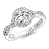 Sparkling bands crossover to support the diamond halo that frames the center stone.