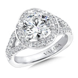 Diamond halo engagement ring mounting with split shank and side stones set in 14k white gold.