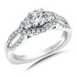 Three diamonds are framed by a single sparkling halo. A pinched open shank draws your eye to the center.
