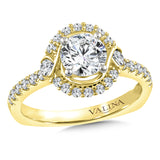 Diamond halo engagement ring mounting set in 14k yellow gold.