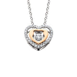 This two tone diamond heart pendant is part of the Diamond Dancer collection, a line of moving diamond jewelry. The center stone is set away from the skin so it constantly shimmy and shakes, dancing with the wearer's slightest movement. The pendant i...